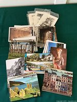 Stack of assorted postcards showing diverse historic and scenic views in color and black & white