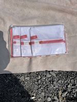 Front view of three mesh laundry bags inside clear case