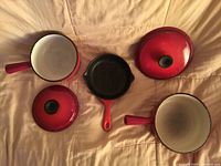 Interior view of two saucepans with lids and skillet