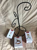 Metal spiral display tree with three Hallmark ornament boxes
