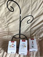 Front view of metal tree with three Hallmark ornament boxes