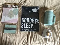 All five new baby shower items laid out on bed