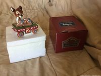 Front view of Bambi Age 2 figurine on styrofoam with box beside