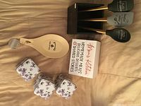 All items laid out: three spatulas, holder, spoon rest, recipe box, three tins