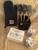 All items arranged showing spatulas, holder, mitt, recipe box, tins