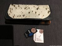 Front view showing hair-on hide flap and attached tags