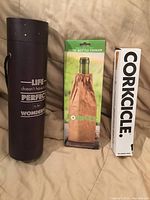 Front view of three items: cylindrical holder, KoverUpz cooler, Corkcicle chiller