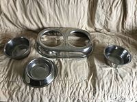 Double feeder base with three bowls arranged on couch