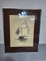 Full front view of framed Degarth sailboat sketch against gray wall and floor.