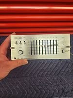 Front of the TOA EQ-910A mono graphic equalizer showing control panel with sliders, knobs and switches.