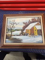 Full view of the framed cabin painting showing the complete artwork and frame.