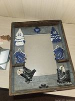 Close-up of the Toronto Maple Leafs decorative photo frame with hockey gloves and skates attached