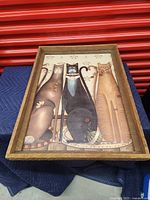 Front view of wooden framed cat picture, showing three stylized cats with decorative background.