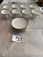 Eight Wedgwood Royal Lapis teacups and eight matching saucers arranged on table from front angle.