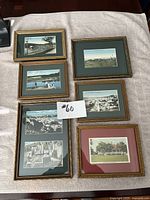 Six vintage framed prints laid out on a white cloth, showing various golf and scenic views from Bermuda and Canada. Frames vary in style and matting color.