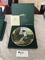 Collector plate in opened green presentation box with Certificate of Authenticity visible