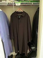 Full view of men’s Bugatti trench jacket hanging in closet, showing overall length and shape.