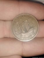 Reverse side showing sailing ship design with 'HALF PENNY' and date 1938