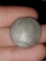 Front side of the coin showing a worn profile portrait with visible patina.