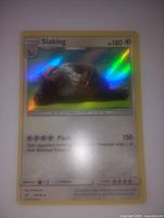 Close-up of Slaking Pokémon card showing front holographic details and text with yellow border.