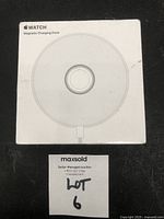 Front view of the white box showing the Apple Watch Magnetic Charging Dock image and product name.