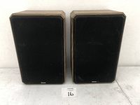 Pair of Boston Acoustic HD7 bookshelf speakers front view showing black fabric covers with Boston logos.