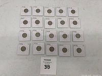 Top-down photo of 24 Buffalo Nickels in individual holders, dated between 1928 and 1937, showing both obverse and reverse sides.