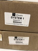 Original Quam SYSTEM 1 speaker boxes with label visible.