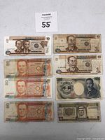 Photo showing multiple Philippine banknotes including 10 and 20 Piso denominations alongside Japanese 1000 Yen and Middle Eastern banknotes.