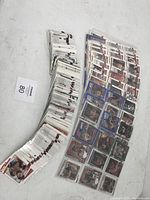 Two wide stacks of MMA trading cards laid flat on white surface with a lot number card visible