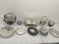 Overall view displaying all nine silver plated items arranged on a table