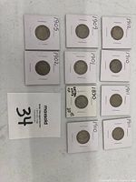 Top-down view of 10 Liberty Head V Nickel coins mounted in white cardboard holders labeled with their respective years from 1890 to 1912, showing the front (obverse) side of the coins.