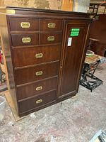 Front view of Kroehler wooden dresser with six drawers and a side cabinet door. Dark wood with brass-colored recessed handles.
