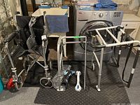 A group photo showing all medical accessories: wheelchair, walker, bed guard, suction grab bar, and grabber tool in a basement setting near laundry machines.