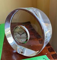 Orrefors glass clock angled showing thickness of the glass and clock face.