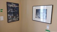 View of the Musee Claude Monet poster and the black and white picture framed on the wall.