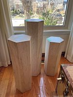 All three marble plinths of varying heights grouped by window.