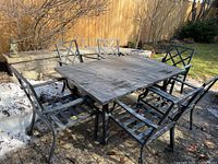 Angled overview of table with six matching chairs on patio