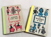 Front-facing cover view of the Andersen's Fairy Tales and The Wizard of Oz junior deluxe edition books showing vintage illustrated art and minor wear.