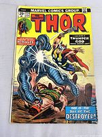 Front cover of the Thor comic book showing Thor fighting the Destroyer. The cover is predominantly yellow with red and blue title text and vintage comic art.