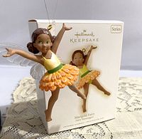 Hallmark Keepsake Marigold Fairy hanging ornament displayed with original box in background.