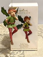 Photo of the Hallmark Keepsake Holly Fairy hanging ornament in its original box showing both figure and box branding.
