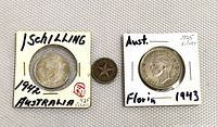 Front side of the 1942 Australian shilling in protective holder, the 1915 Cuban 10 centavos showing star design, and the 1943 Australian florin in holder.