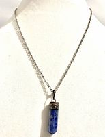 Full view of necklace on display stand showing length and pendant shape