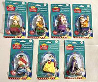 Seven vintage illuminated Disney Snow White & the Seven Dwarfs character ornaments on mini string lights in original packaging, showing front view with all characters arranged