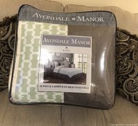 Photo of the closed bed ensemble packaging showing the brand Avondale Manor King size 16 piece bed set.