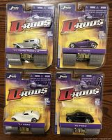 Four Jada Toys D-Rods 1/64 scale Ford model cars still in original packaging, showing clear labels and packaging condition.