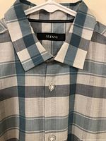 Close-up photo of collar and brand label 'Alfani' on checkered blue and white dress shirt.