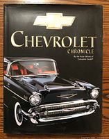 Front cover of Chevrolet Chronicle hardcover book showing a black classic Chevrolet car with red interior and gold Chevrolet logo.