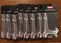 Eight new clear acrylic plate holders still attached to retail packaging, showing front view with Roscan branding.